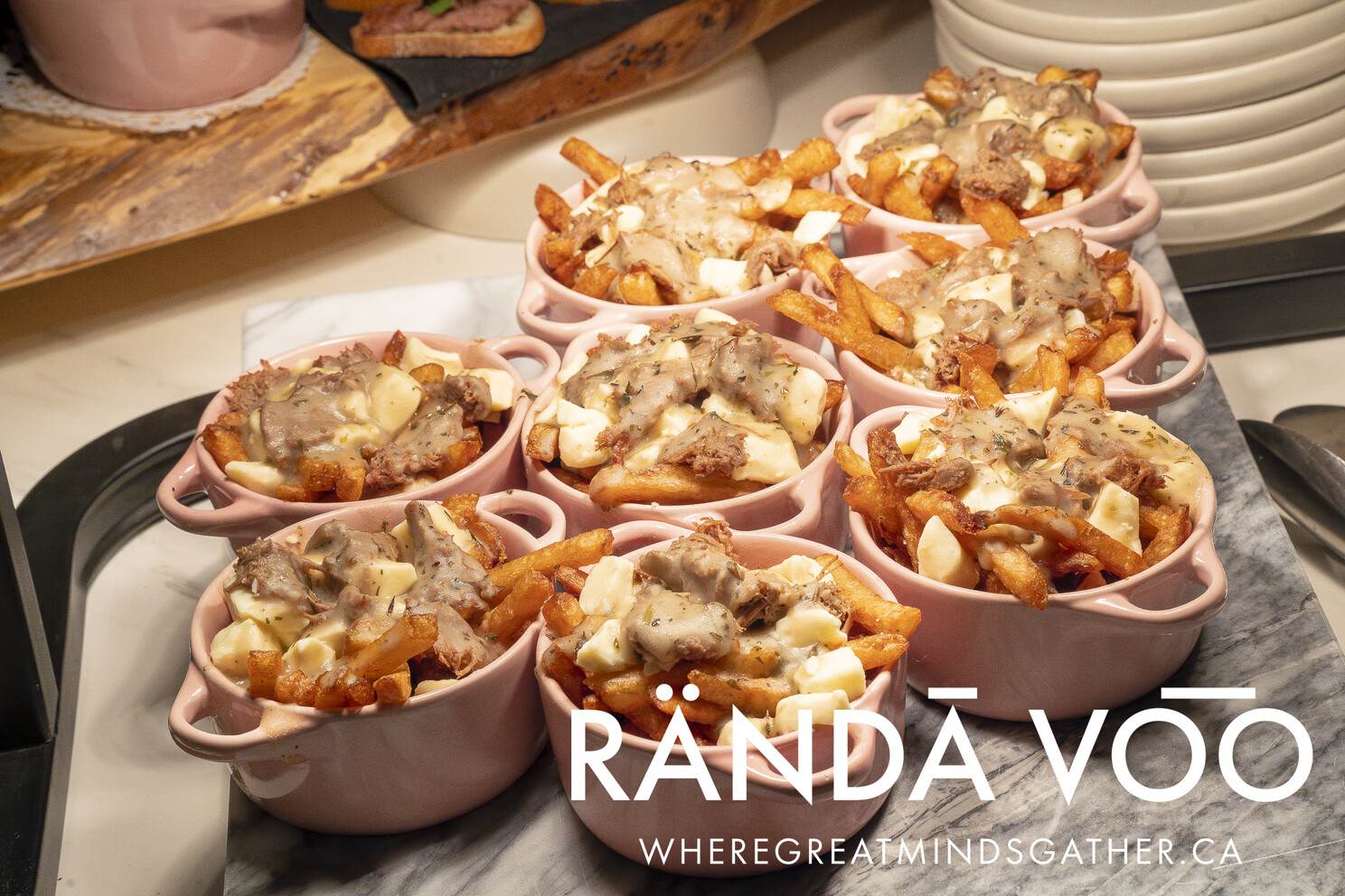 Individual bowls of poutine prepared for guests.