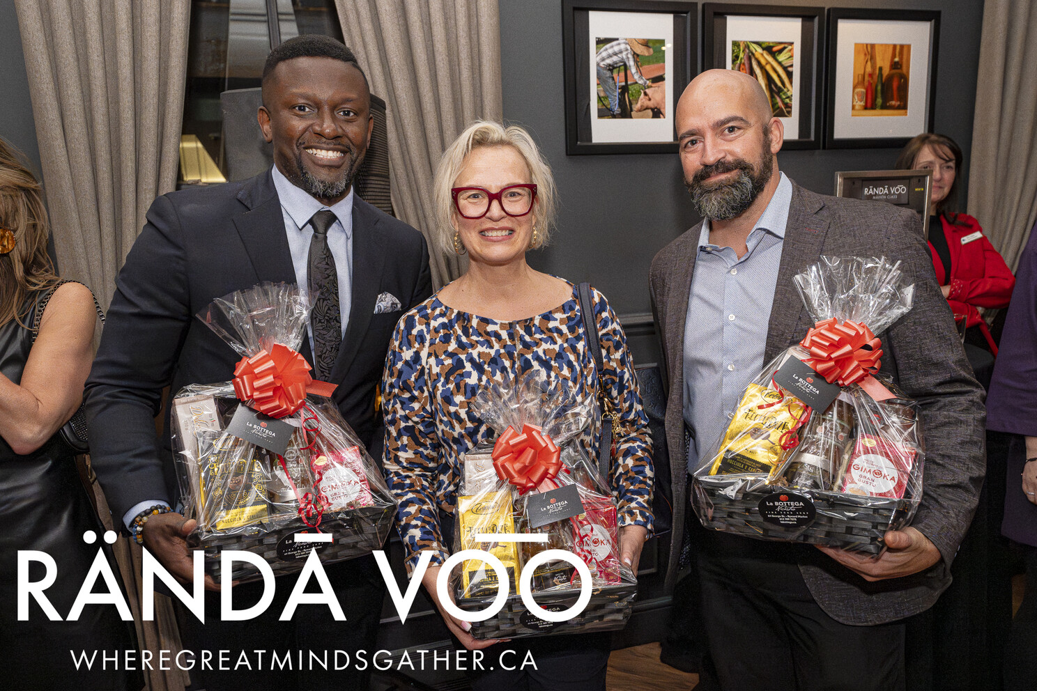 Three guests holding gift baskets at Business. Bubbles. Seafood.