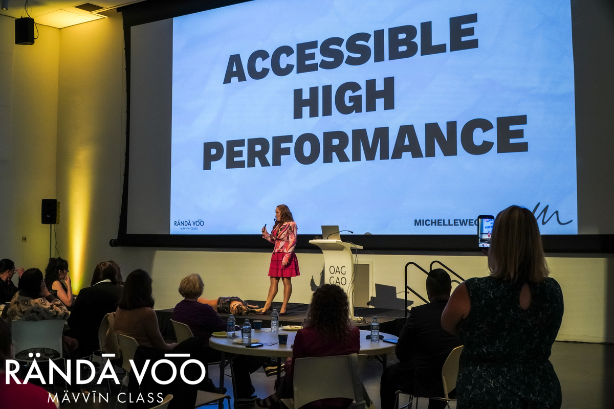 Michelle Weger addressing the room beneath her Accessible High Performance presentation slide.