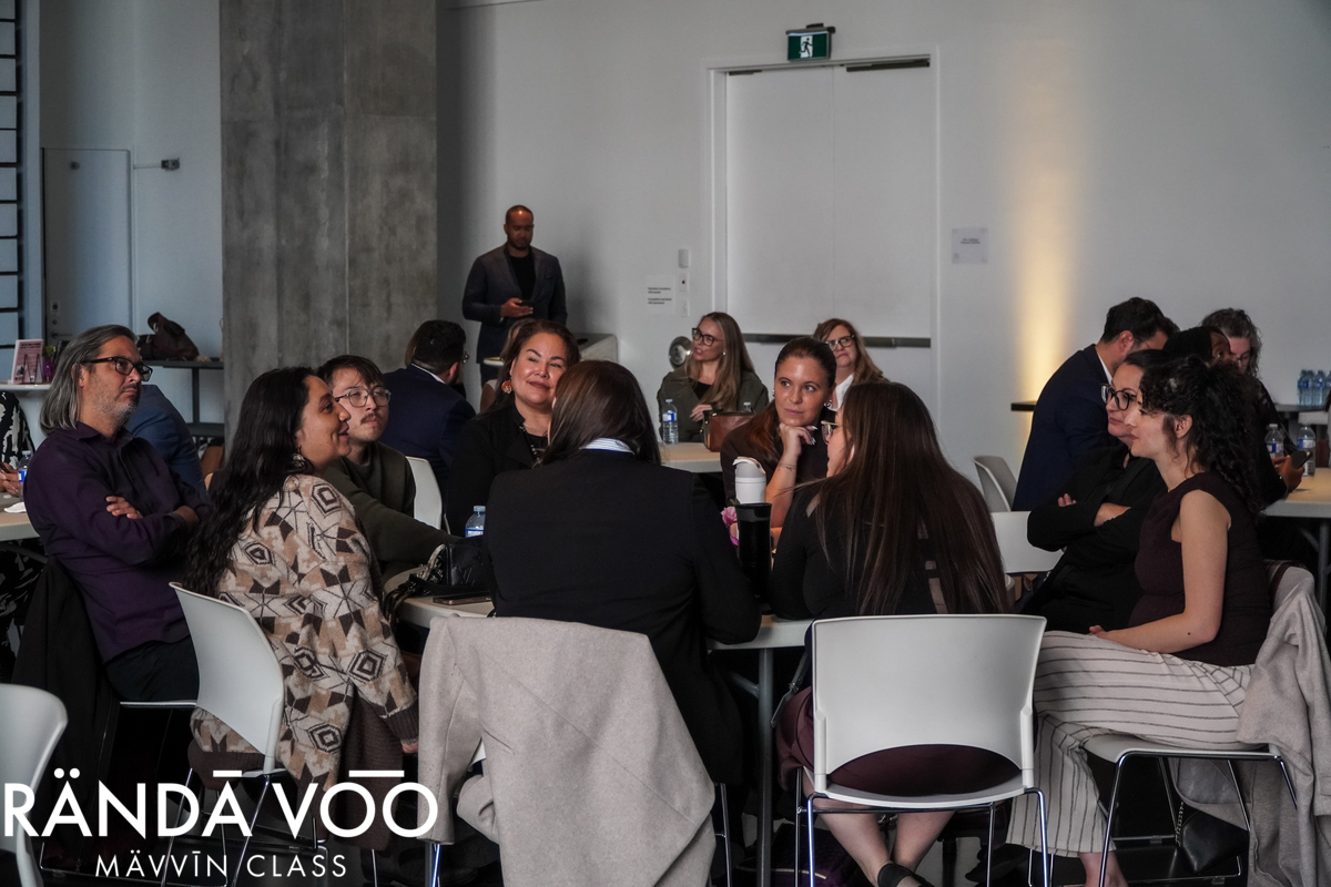 Guests sharing perspectives around a table during peer dialogue at MÄVVĪNCLASS The Capacity Room.