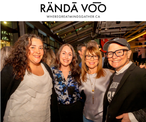 Four guests posing together at Queen St. Fare beneath RÄNDĀ VO͞O branding.