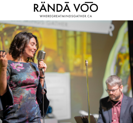 A singer performing beside a keyboard player, beneath RÄNDĀ VO͞O branding.