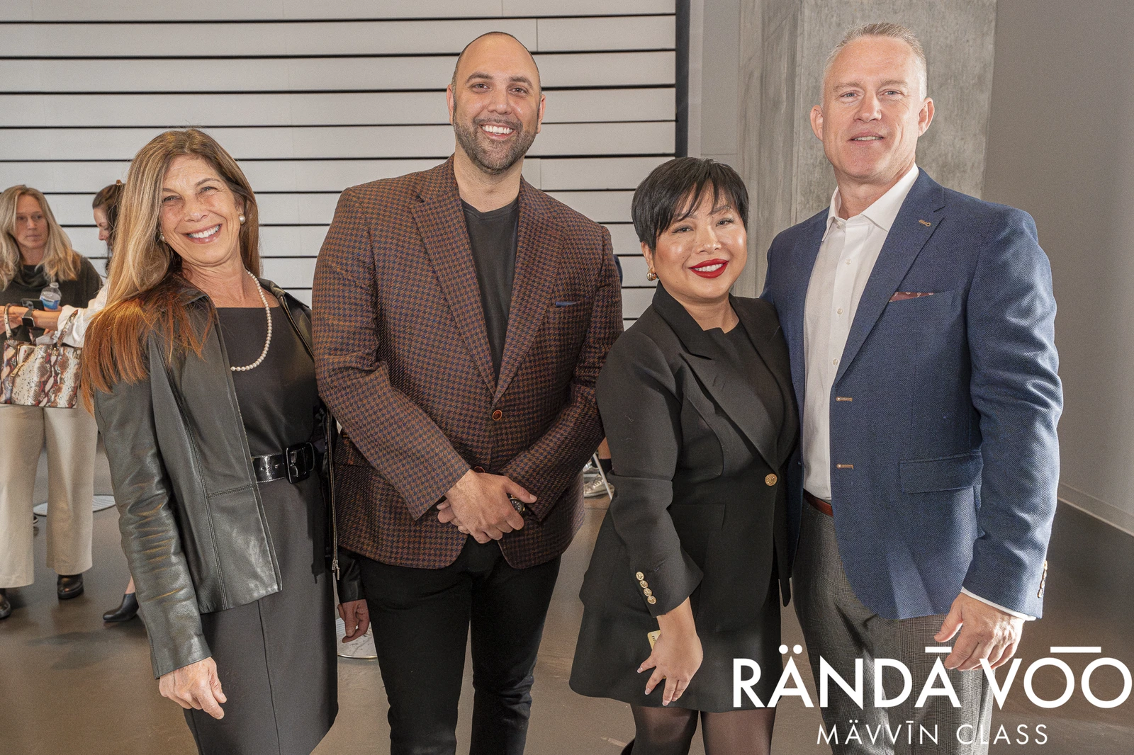 Four RÄNDĀ VO͞O business community attendees posing together at a MÄVVĪNCLASS event.
