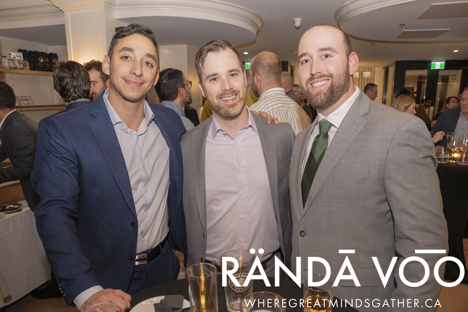 Three guests posing together during the grand finale reception.