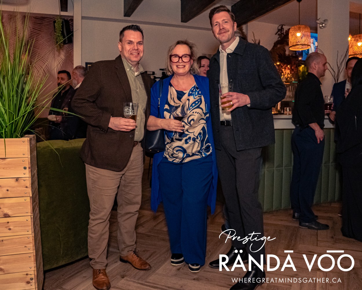 Three guests posing together at the Prestige reception.