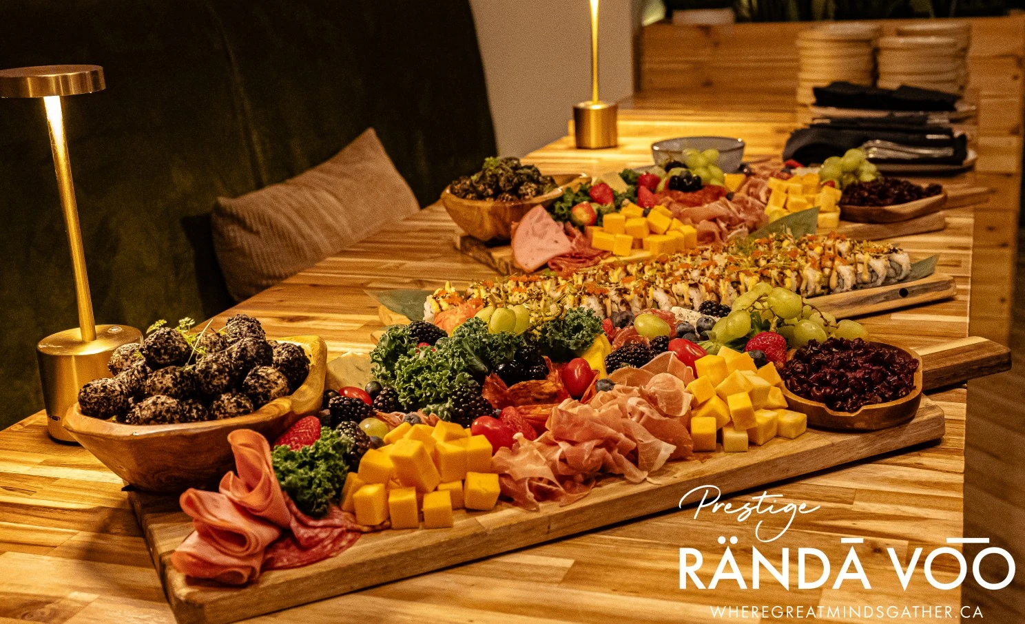 A grazing table with cheese, fruit, and charcuterie at HEIST Manotick, with RÄNDĀ VO͞O Prestige branding.
