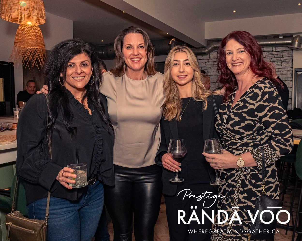 Four guests posing together at HEIST Manotick, with RÄNDĀ VO͞O Prestige branding.