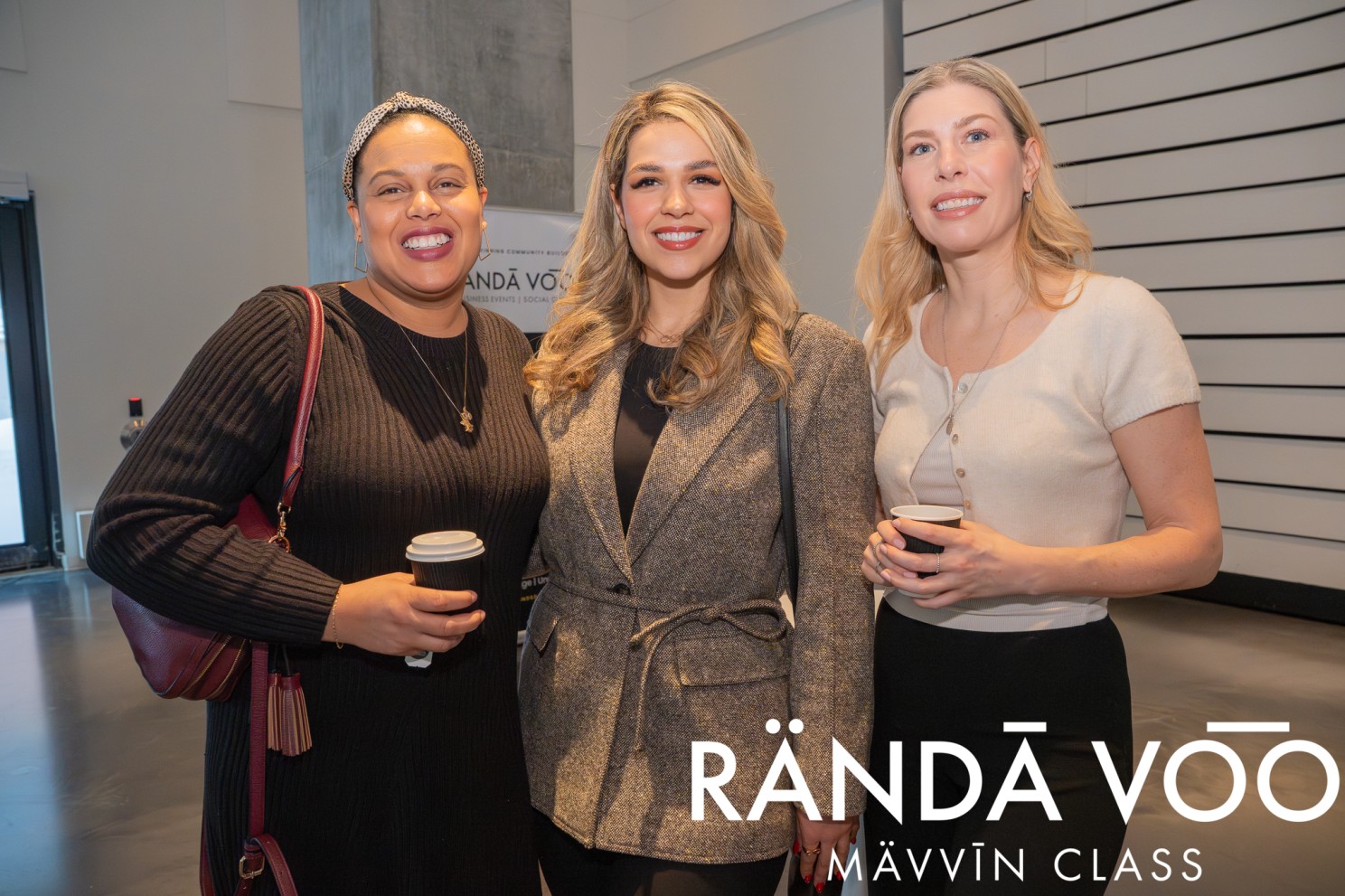 Three MÄVVĪNCLASS guests smiling together during the gathering.