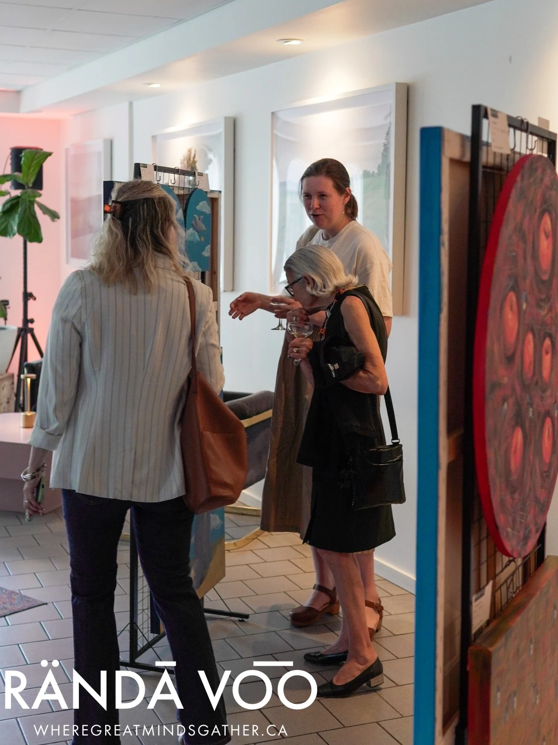 Guests talking beside displayed artwork at Parlour.