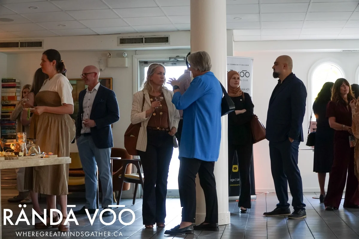 Guests mingling and talking near a refreshment table at Parlour, with RÄNDĀ VO͞O branding.