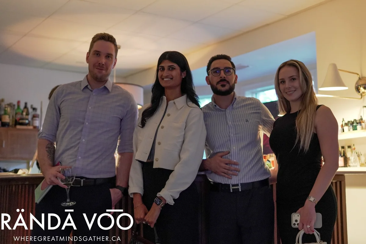 Four guests posing together at Parlour, with RÄNDĀ VO͞O branding.